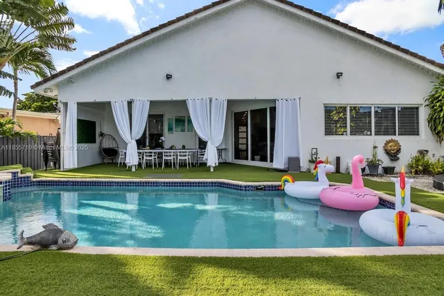 a view of swimming pool with a table and chairs