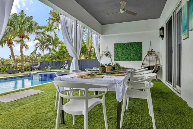 a view of swimming pool with a dining table and chairs