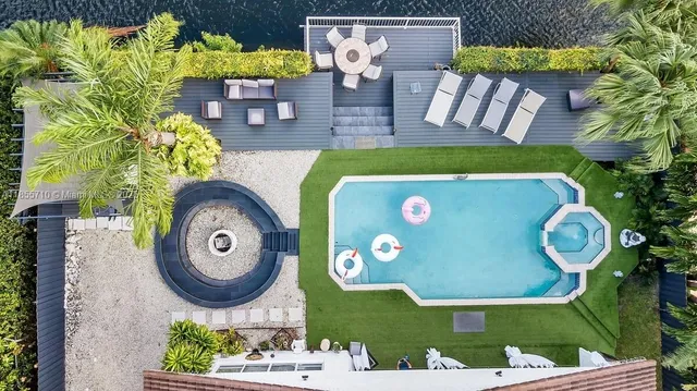 a living room with couches a coffee table and a dining table with garden view