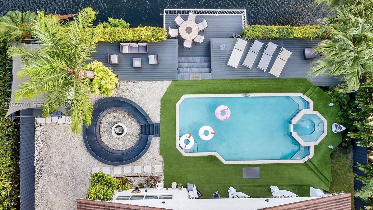 205 North 31st Avenue, Unit 1 Hollywood, FL 33021 - Photo 32 of 42 a view of swimming pool with a dining table and chairs
