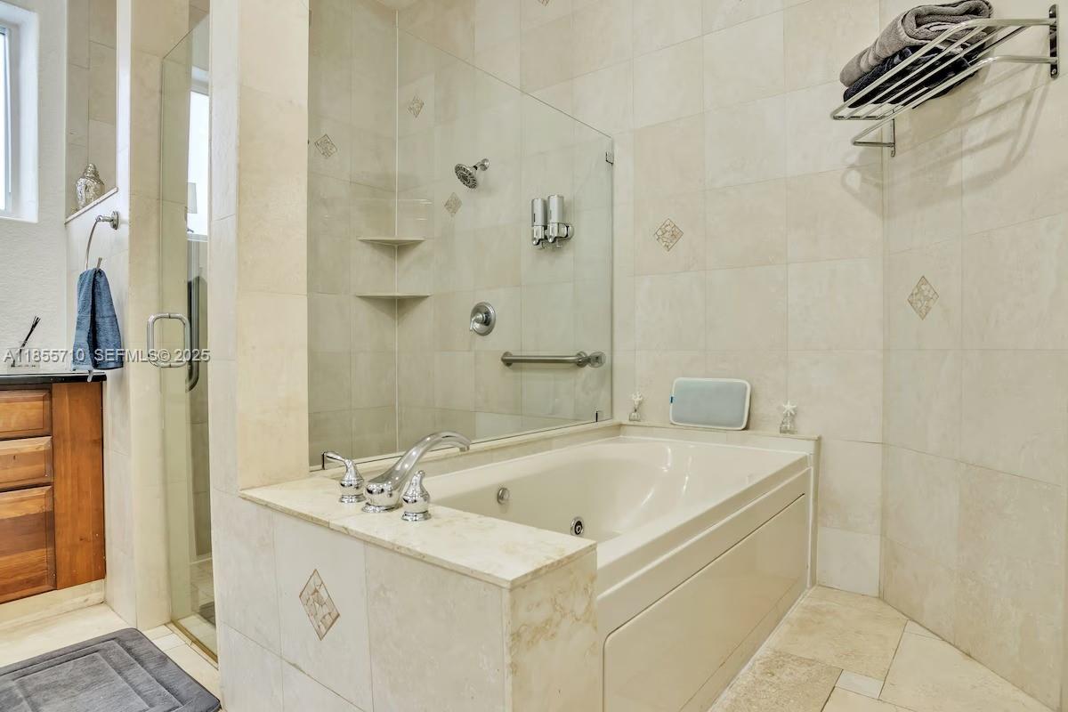 205 North 31st Avenue, Unit 1 Hollywood, FL 33021 - Photo 36 of 42 a bathroom with a sink a mirror and a bathtub