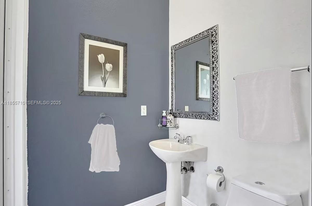 205 North 31st Avenue, Unit 1 Hollywood, FL 33021 - Photo 38 of 42 a bathroom with a sink and mirror