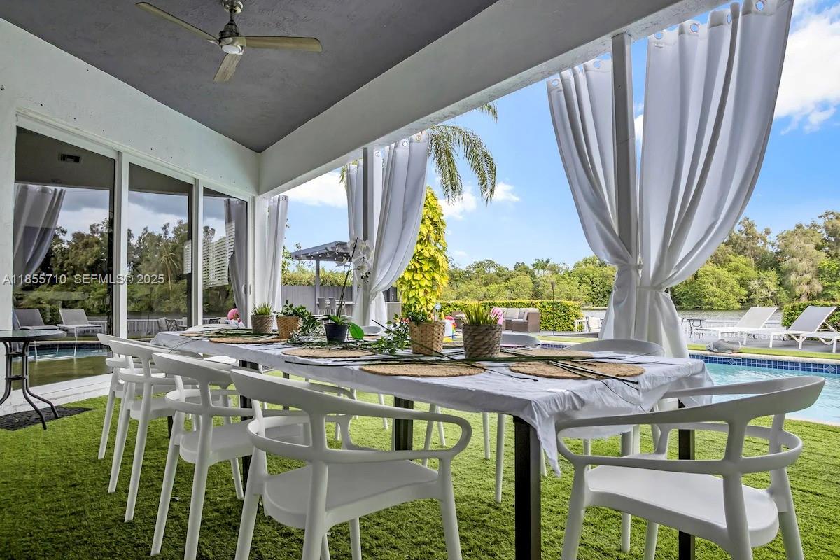 205 North 31st Avenue, Unit 1 Hollywood, FL 33021 - Photo 40 of 42 a dining room with furniture a rug and a floor to ceiling window