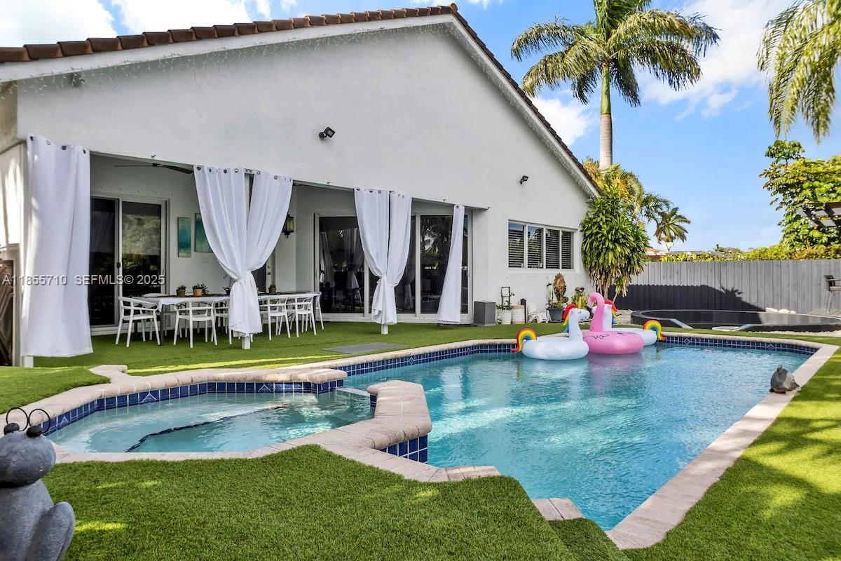 205 North 31st Avenue, Unit 1 Hollywood, FL 33021 - Photo 4 of 42 a view of a house with swimming pool yard and furniture