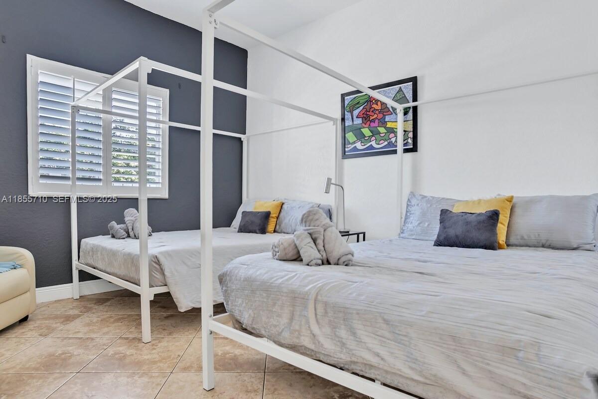 205 North 31st Avenue, Unit 1 Hollywood, FL 33021 - Photo 41 of 42 a bedroom with a bed and a window