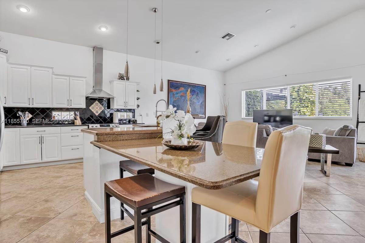 205 North 31st Avenue, Unit 1 Hollywood, FL 33021 - Photo 9 of 42 a view of kitchen with dining table and chairs