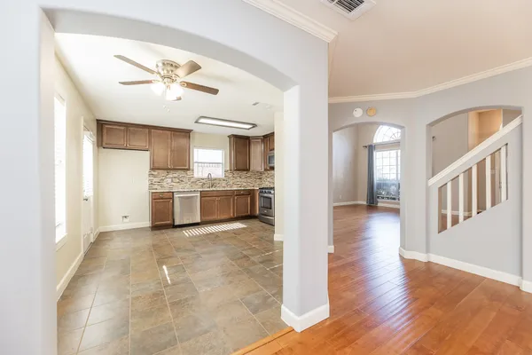a view of a kitchen with wooden floor and a kitchen