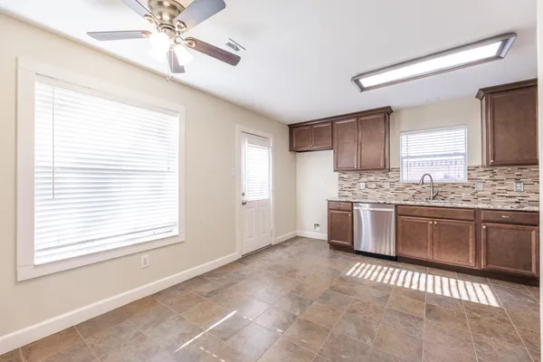 a kitchen with stainless steel appliances kitchen island granite countertop a stove a sink and a refrigerator