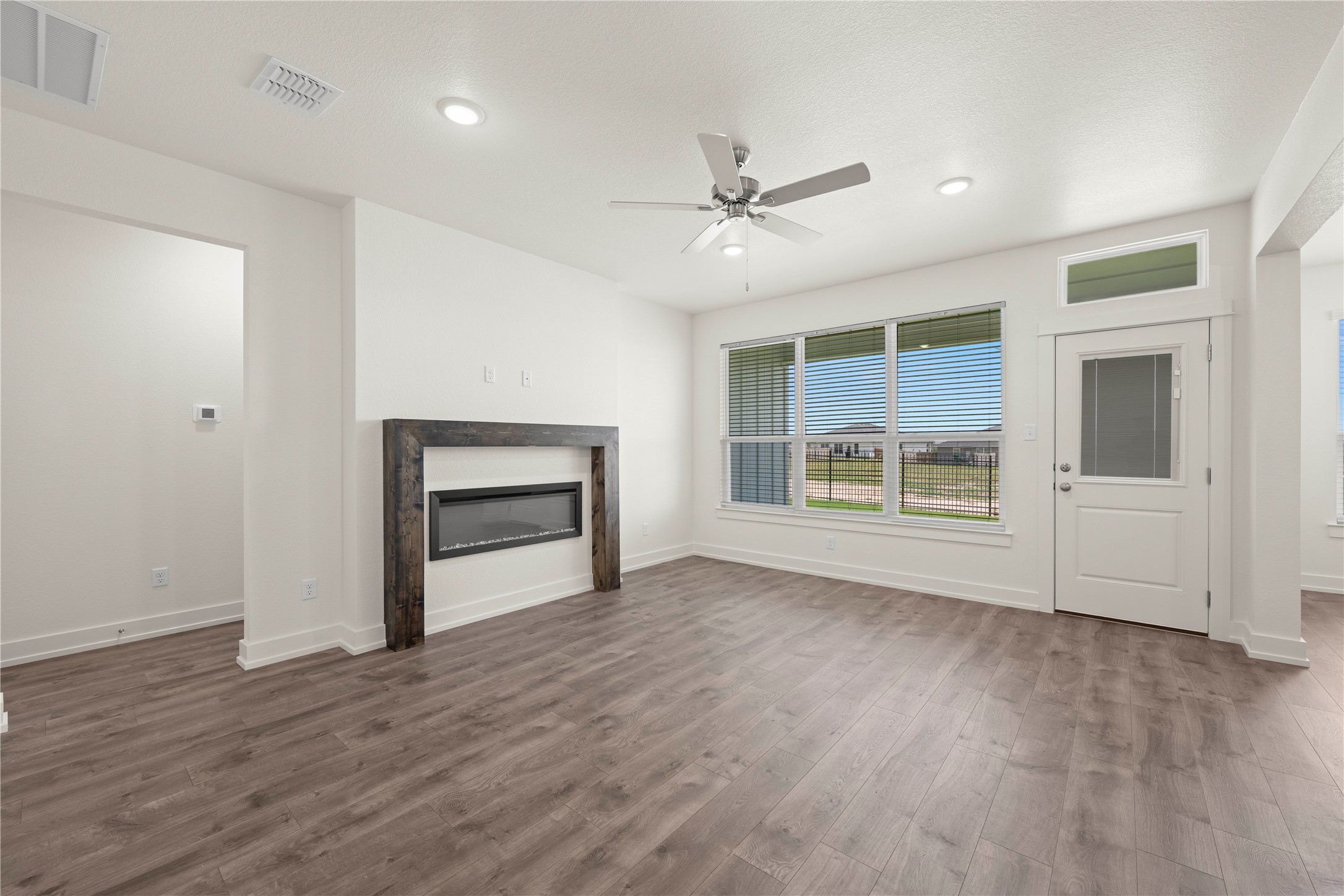 564 Gus Loop Georgetown, TX 78626 - Photo 9 of 32 a view of an empty room with a window and fireplace