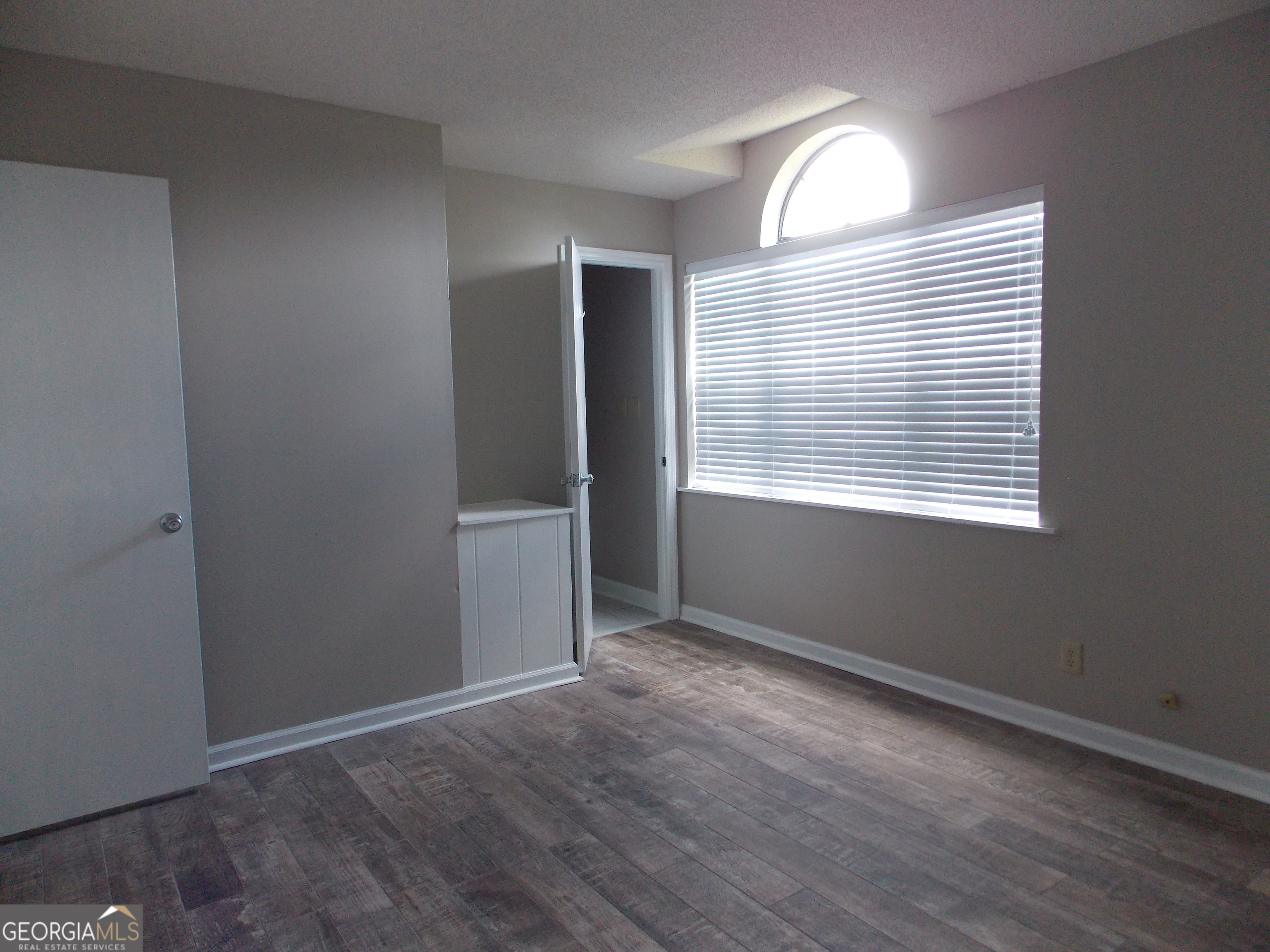 224 Pretoria Rushing Road Statesboro, GA 30461 - Photo 9 of 11 an empty room with wooden floor and windows