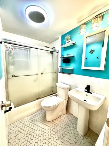a bathroom with a sink toilet and shower