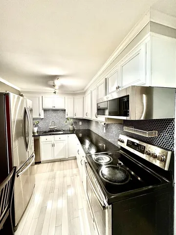 a kitchen with a stove a sink and a microwave