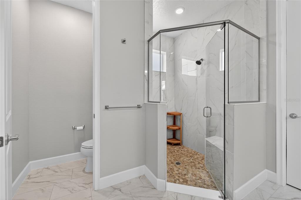 5961 Blakeney Loop Apollo Beach, FL 33572 - Photo 15 of 42 a bathroom with a granite countertop shower