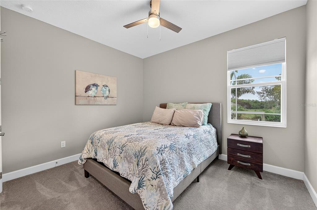 5961 Blakeney Loop Apollo Beach, FL 33572 - Photo 27 of 42 a bed sitting in a bedroom next to a window