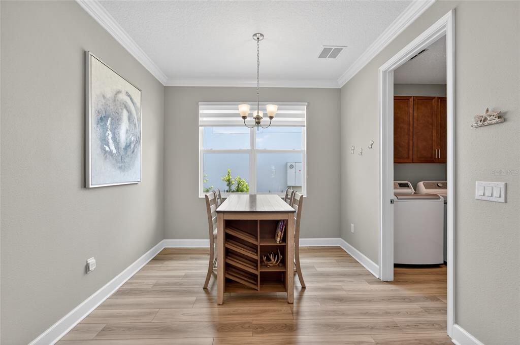 5961 Blakeney Loop Apollo Beach, FL 33572 - Photo 29 of 42 a view of a dining room with furniture window and wooden floor