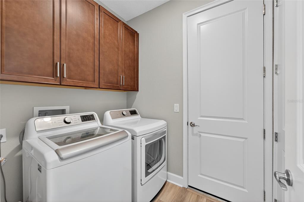 5961 Blakeney Loop Apollo Beach, FL 33572 - Photo 30 of 42 a utility room with dryer and washer