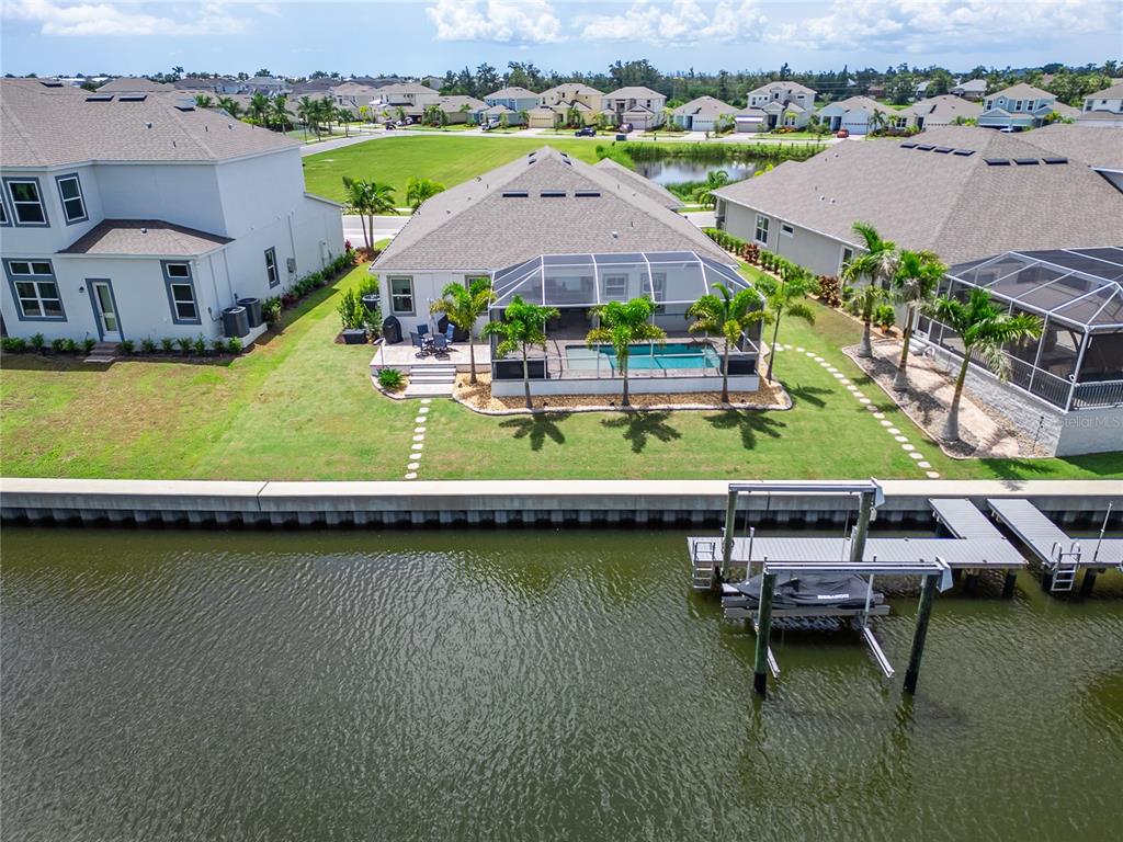 5961 Blakeney Loop Apollo Beach, FL 33572 - Photo 3 of 42 an aerial view of a house with a garden and lake view