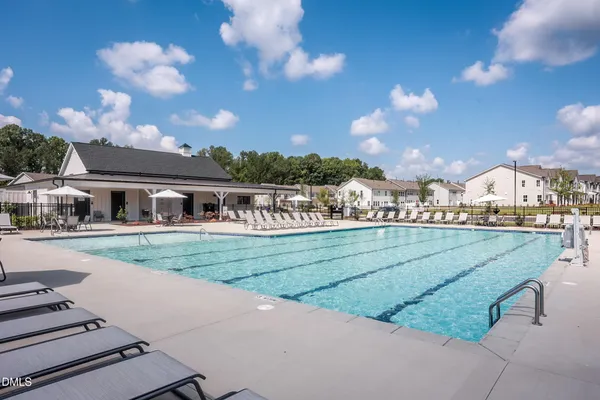 a view of a swimming pool and lounge chairs