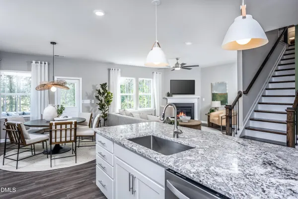 a kitchen with stainless steel appliances granite countertop a refrigerator a stove and a sink