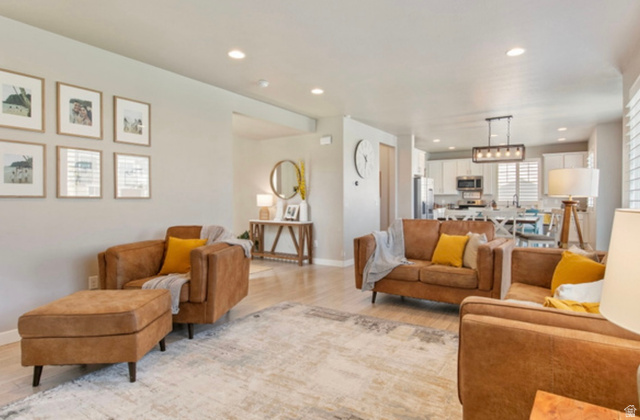 1295 East Granite Peak Road Eagle Mountain, UT 84005 - Photo 10 of 35 Open-concept living space featuring wood-finish flooring and recessed lighting