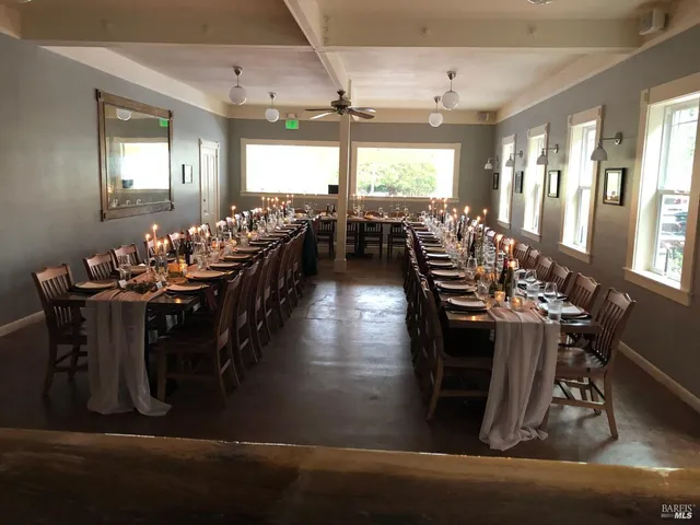 a dining room with furniture and wooden floor