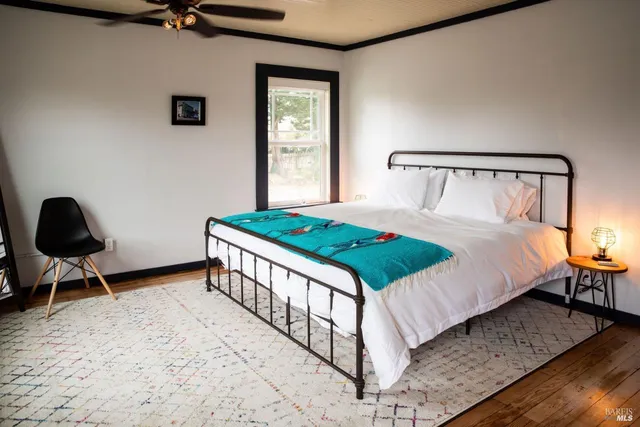 a bedroom with a bed a table and chair