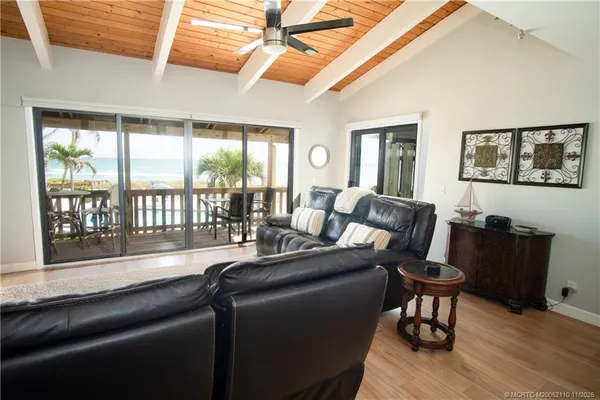 a living room with furniture and a floor to ceiling window