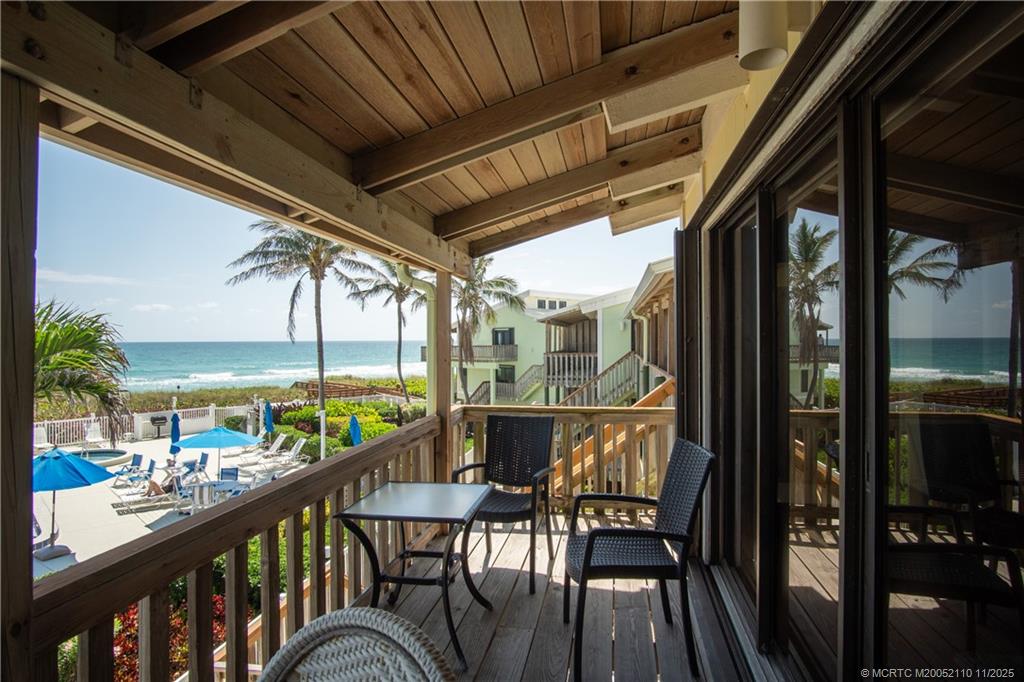 2355 Northeast Ocean Boulevard, Unit 120B Stuart, FL 34996 - Photo 13 of 26 a view of a city from a balcony with furniture