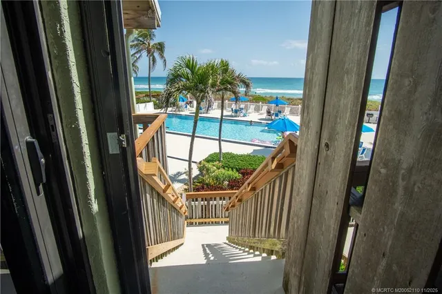 a view of a swimming pool with outdoor seating