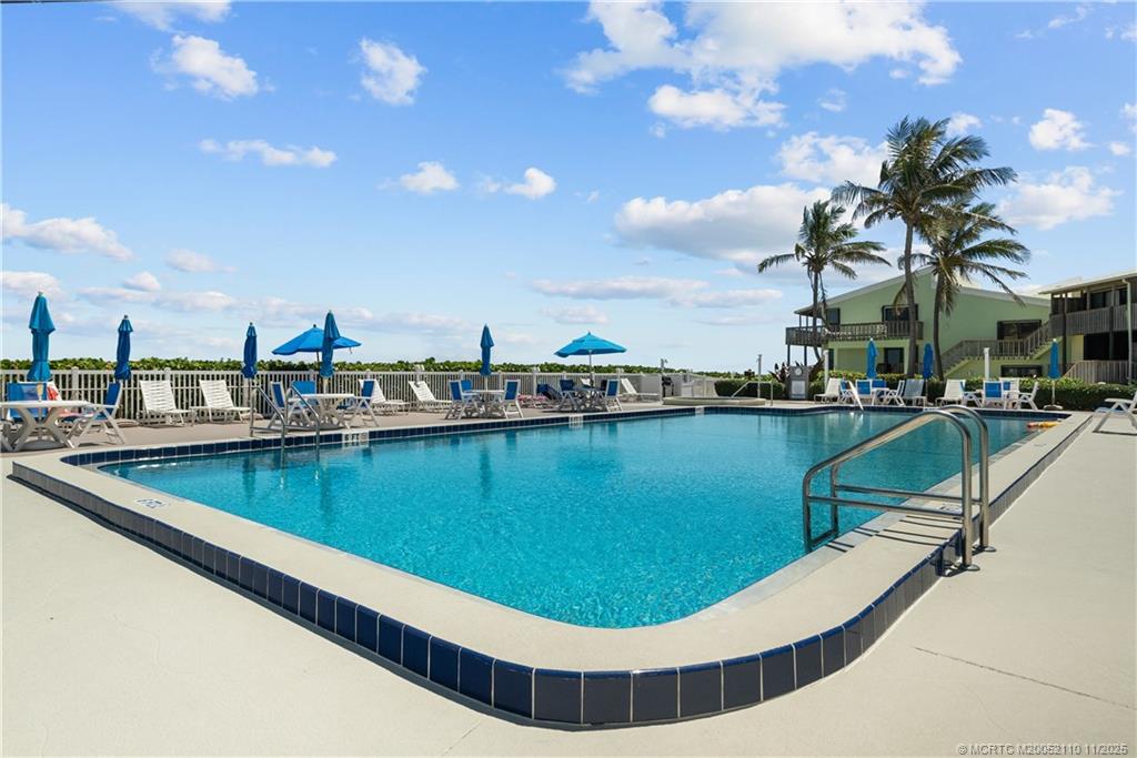 2355 Northeast Ocean Boulevard, Unit 120B Stuart, FL 34996 - Photo 17 of 26 a view of a swimming pool with outdoor seating