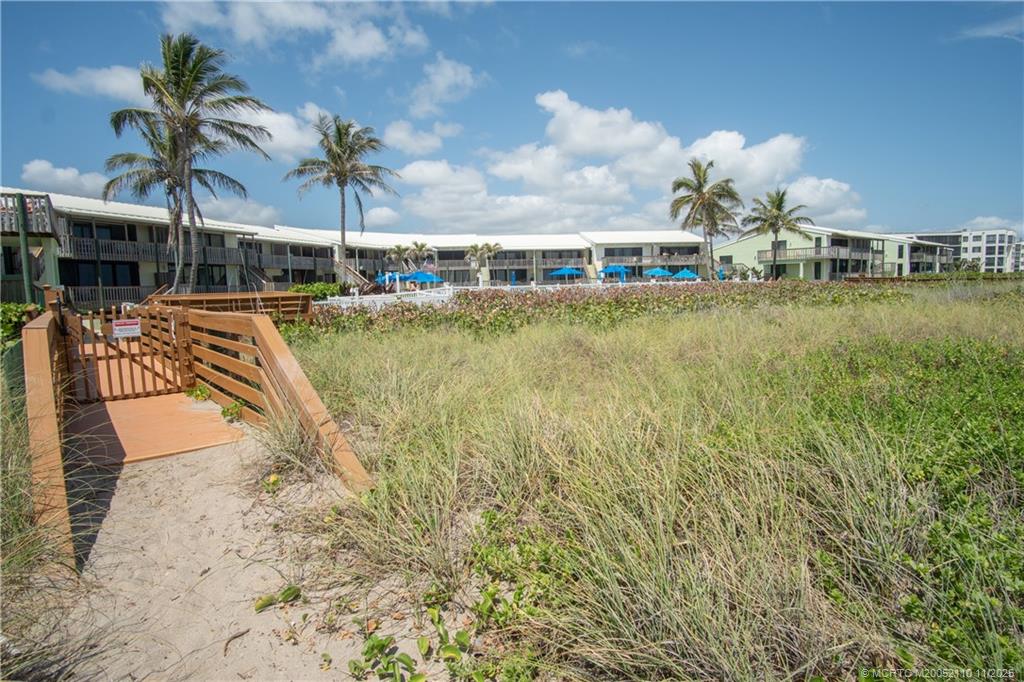 2355 Northeast Ocean Boulevard, Unit 120B Stuart, FL 34996 - Photo 21 of 26 a swimming pool with outdoor seating and yard