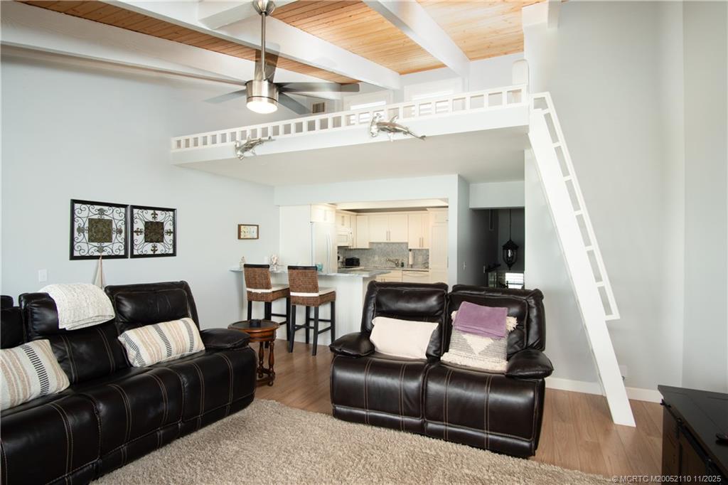 2355 Northeast Ocean Boulevard, Unit 120B Stuart, FL 34996 - Photo 3 of 26 a living room with furniture and a flat screen tv