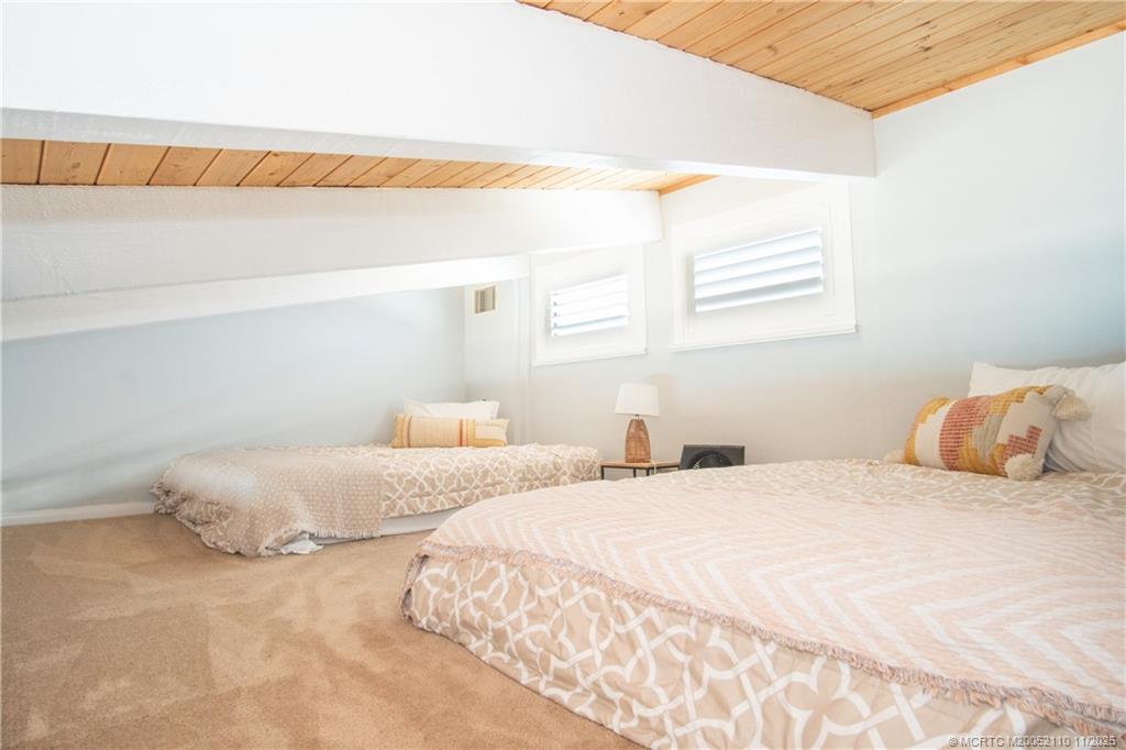 2355 Northeast Ocean Boulevard, Unit 120B Stuart, FL 34996 - Photo 4 of 26 a bedroom with a bed and a window