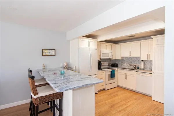 a kitchen with a stove a refrigerator and a dining table