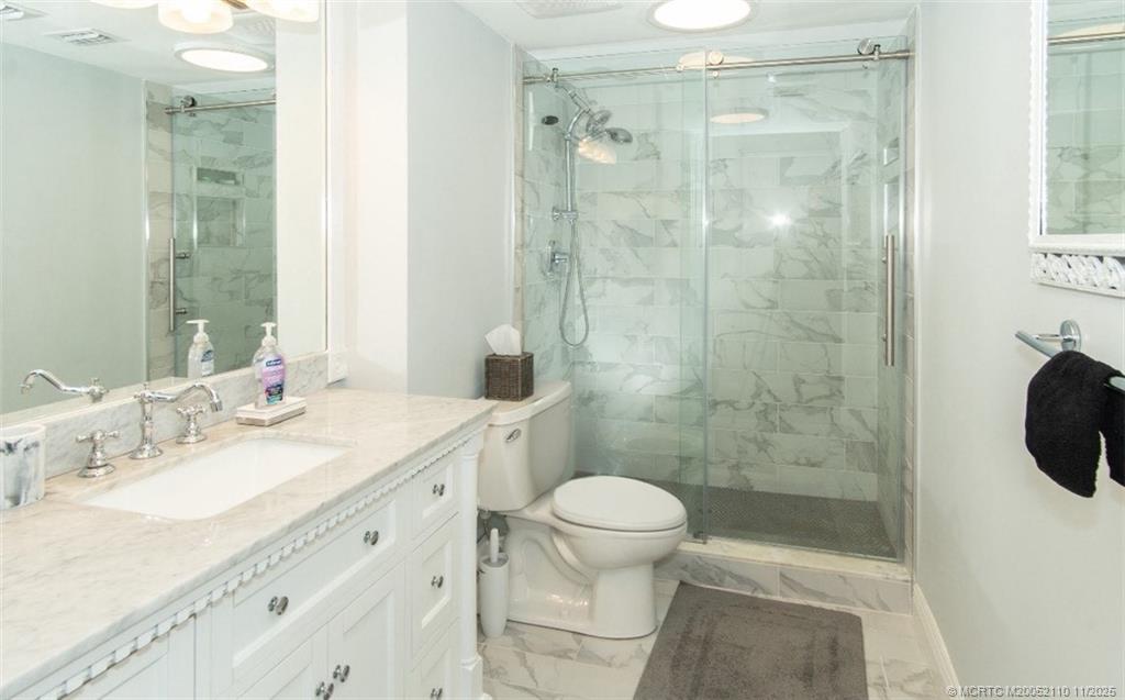 2355 Northeast Ocean Boulevard, Unit 120B Stuart, FL 34996 - Photo 8 of 26 a bathroom with a sink a toilet and shower