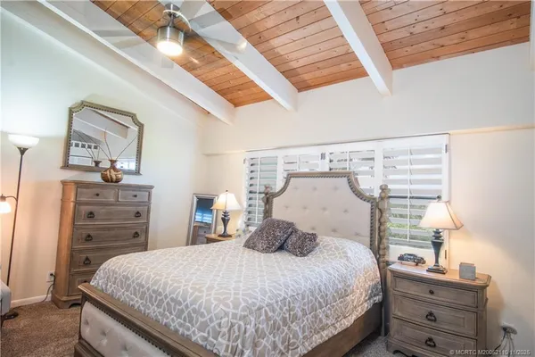 a bedroom with a bed and flat screen tv