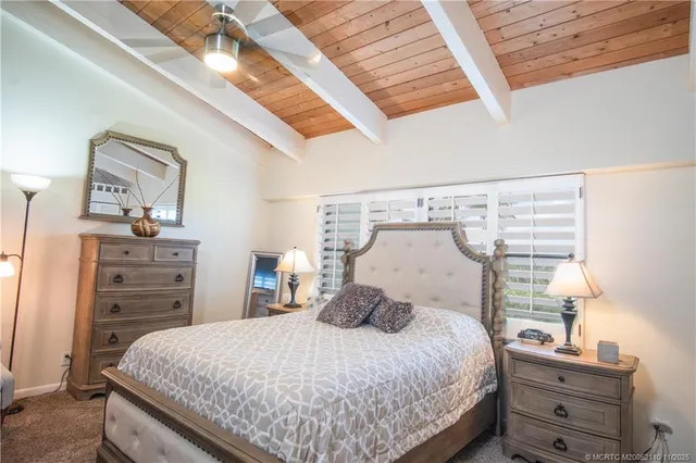 a bedroom with a bed and flat screen tv