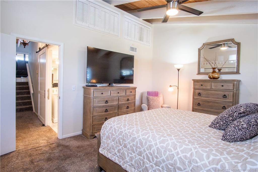 2355 Northeast Ocean Boulevard, Unit 120B Stuart, FL 34996 - Photo 10 of 26 a bedroom with a bed and flat screen tv