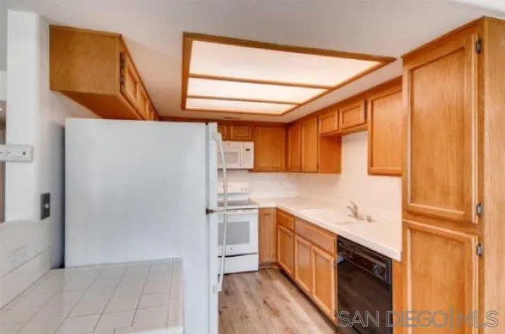 13919 Midland Road Poway, CA 92064 - Photo 5 of 7 a kitchen with stainless steel appliances granite countertop a refrigerator and a stove top oven