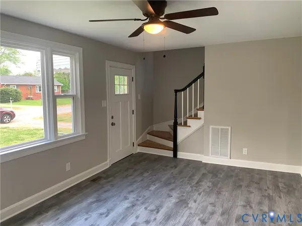 wooden floor in an empty room with a window