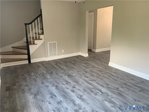 wooden floor with view of entryway