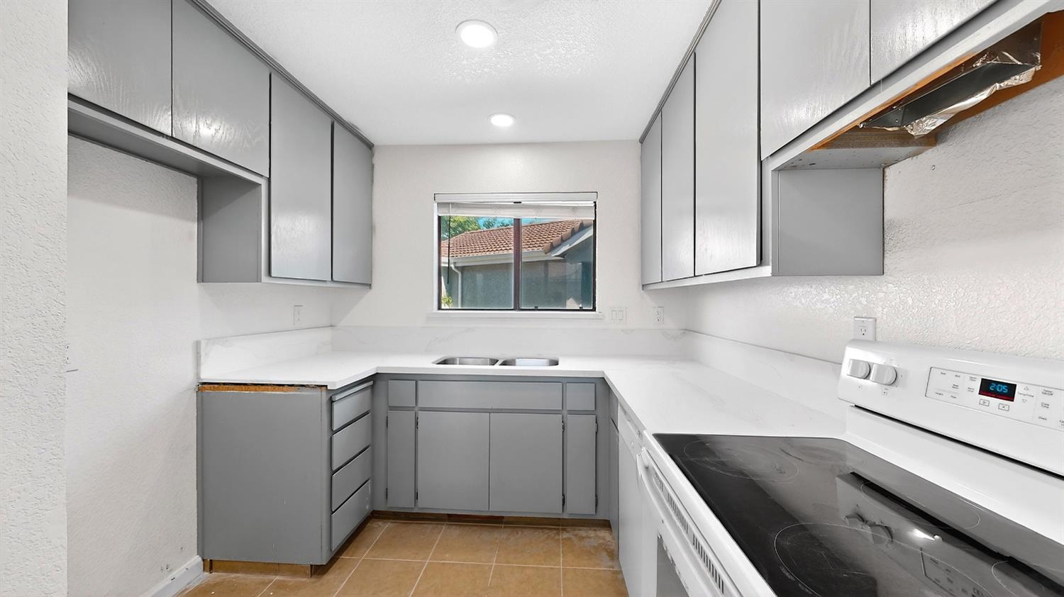 3632 La Mancha Place Turlock, CA 95382 - Photo 15 of 31 a kitchen with a sink stove and cabinets