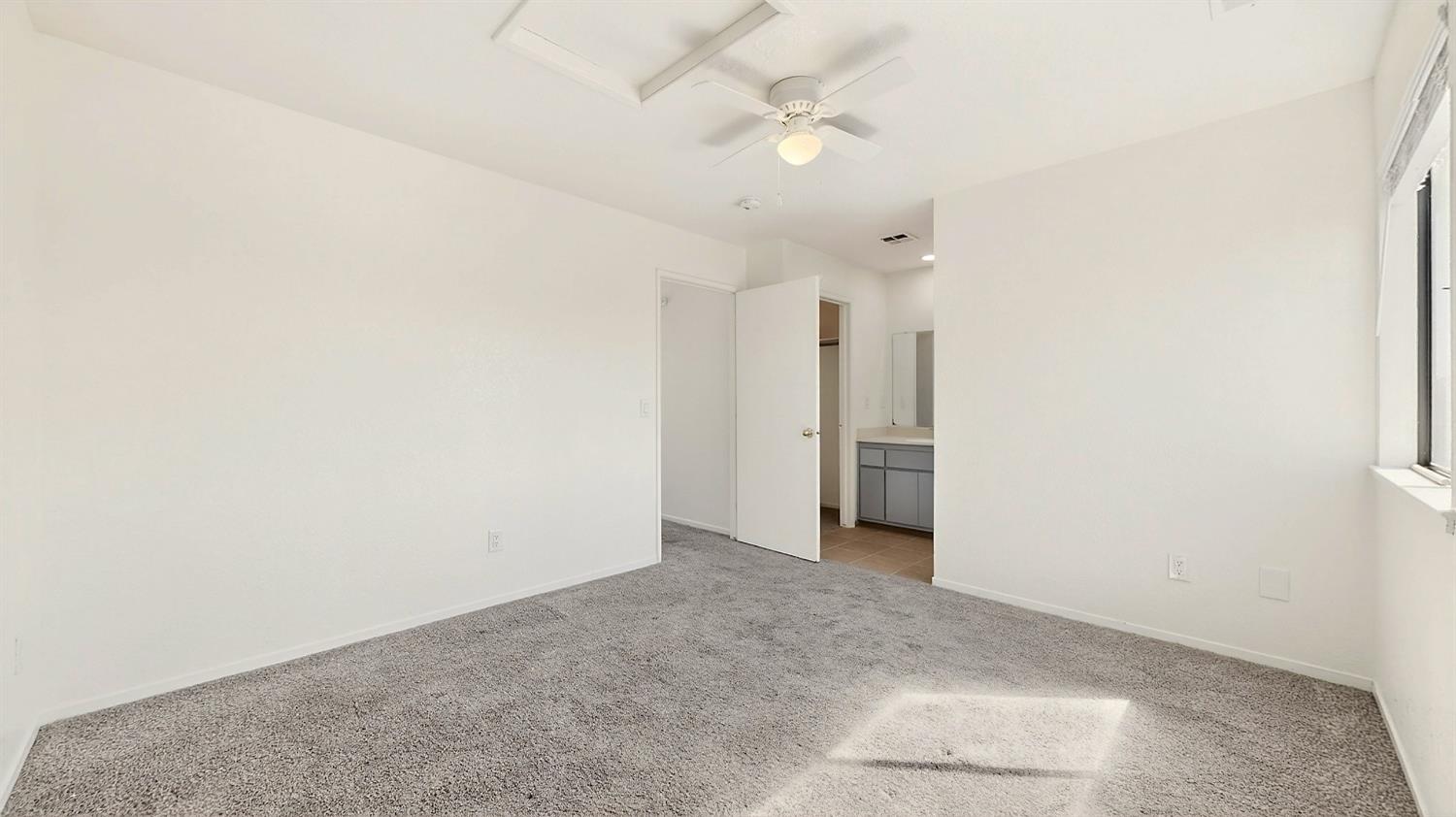 3632 La Mancha Place Turlock, CA 95382 - Photo 20 of 31 an empty room with a ceiling fan and a window
