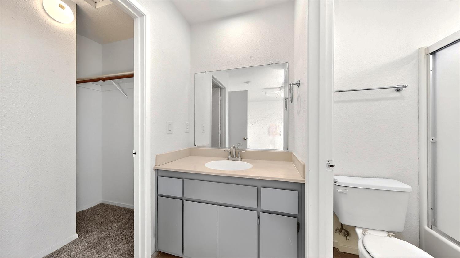 3632 La Mancha Place Turlock, CA 95382 - Photo 21 of 31 a bathroom with a sink toilet vanity and a mirror