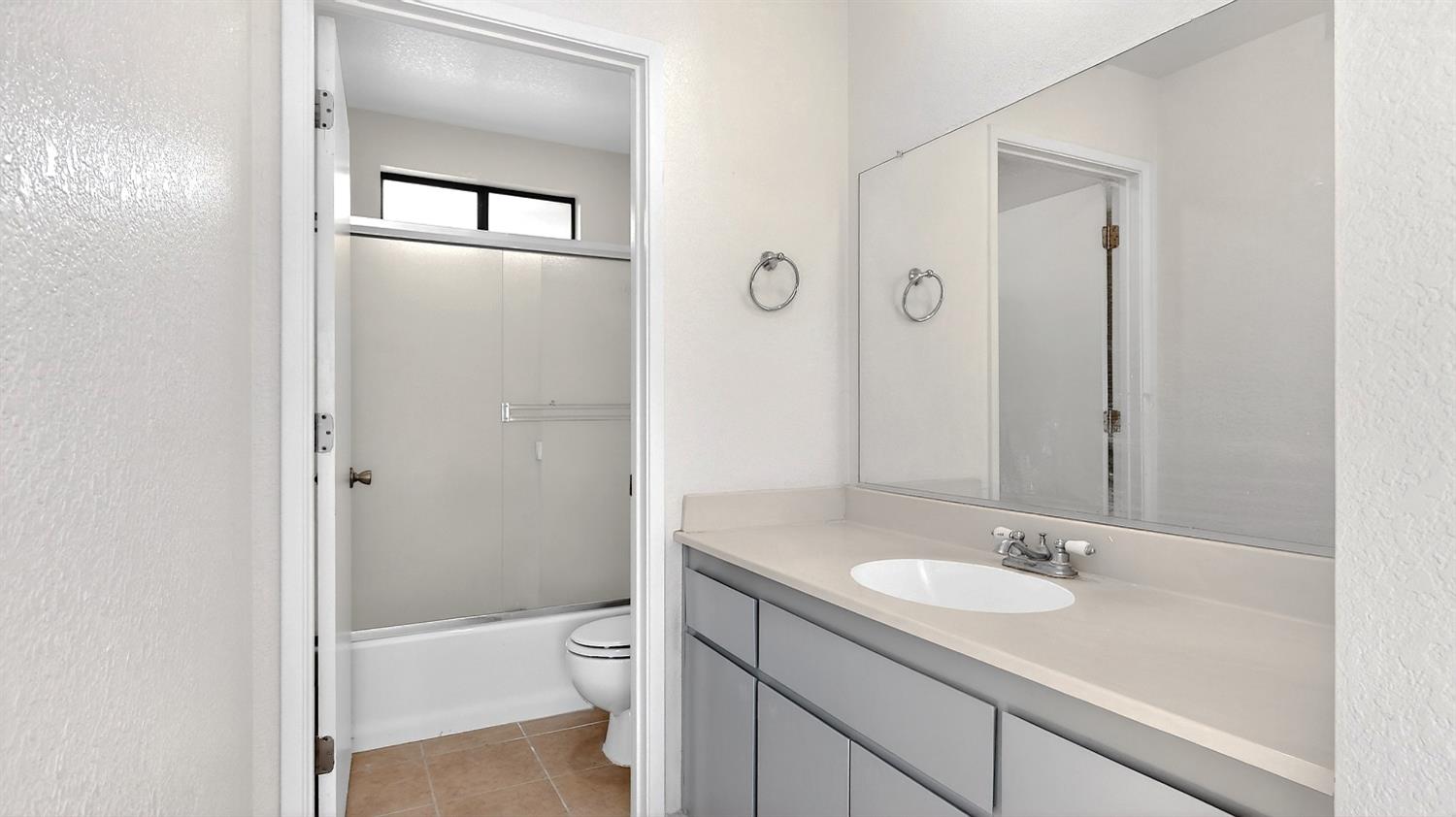 3632 La Mancha Place Turlock, CA 95382 - Photo 25 of 31 a bathroom with a granite countertop sink a toilet and shower