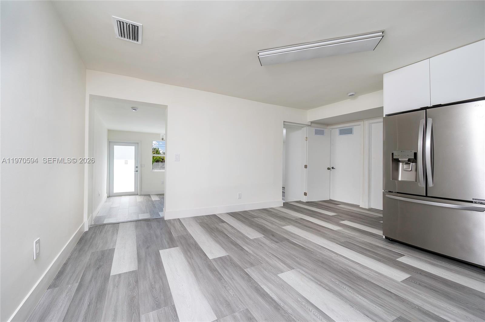 2433 Northwest 97th Street Miami, FL 33147 - Photo 14 of 41 a view of a kitchen with a closet and wooden floor