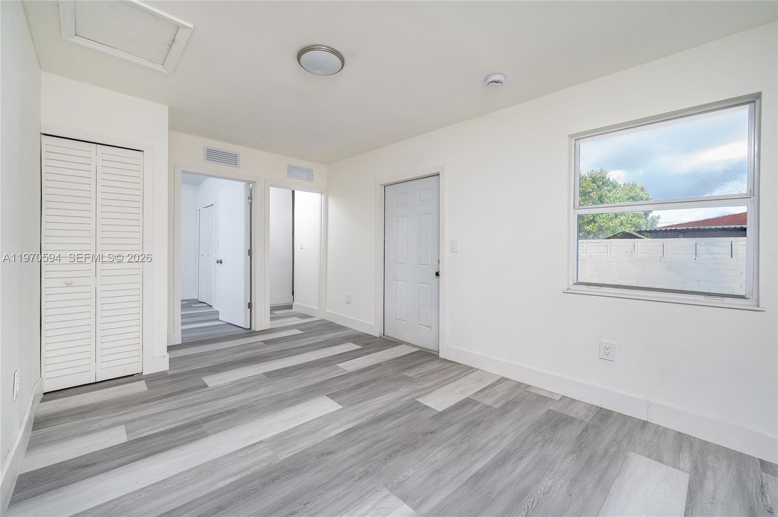 2433 Northwest 97th Street Miami, FL 33147 - Photo 20 of 41 a view of a room with wooden floor and window