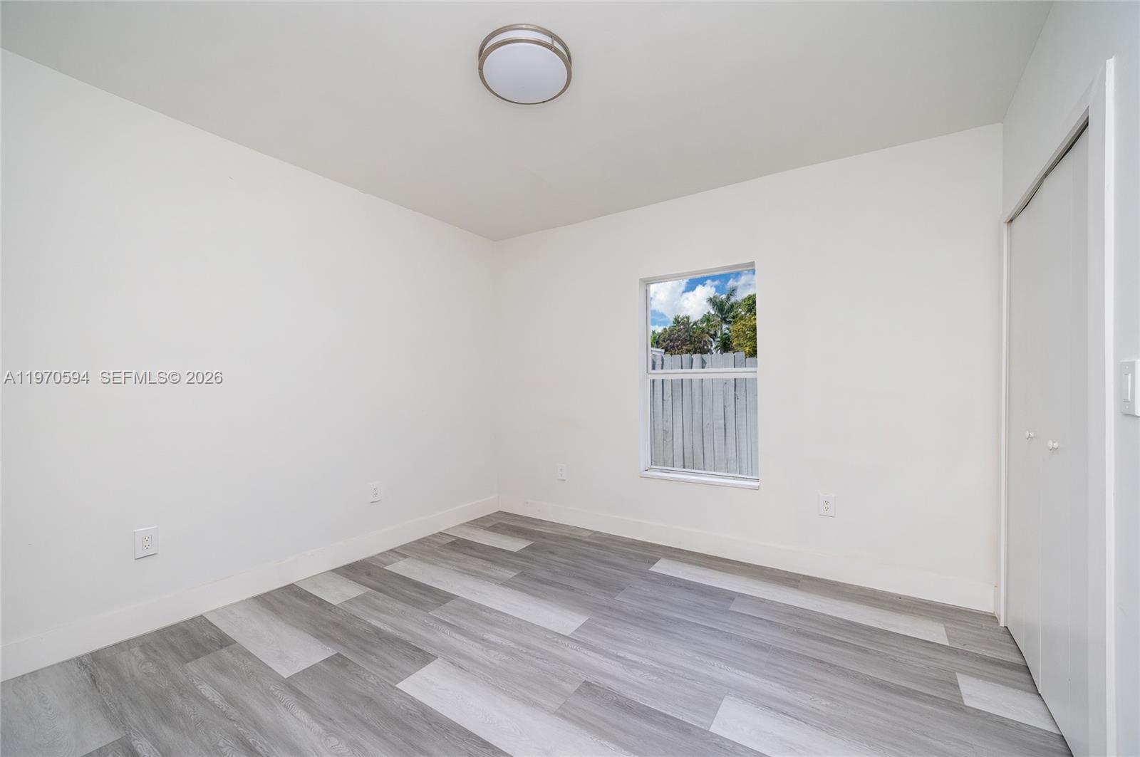 2433 Northwest 97th Street Miami, FL 33147 - Photo 21 of 41 a view of empty room with wooden floor