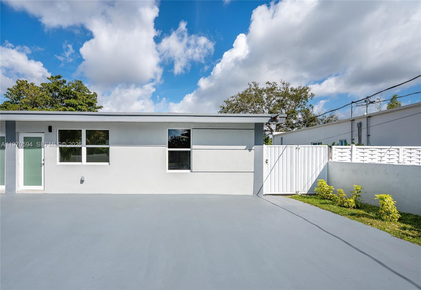 2433 Northwest 97th Street Miami, FL 33147 - Photo 23 of 41 a view of a house with a yard and potted plants