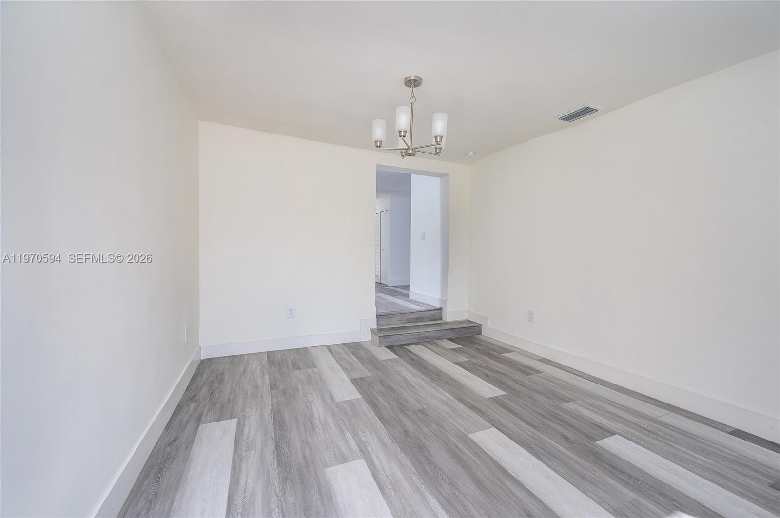 2433 Northwest 97th Street Miami, FL 33147 - Photo 25 of 41 a view of room with window and hardwood floor